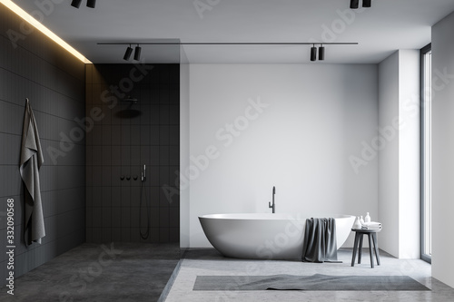 Fotografía White and black bathroom with tub and shower