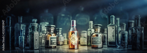 Cuadros en Lienzo A bottle of poison on a background of old medical, chemistry and pharmacy glass