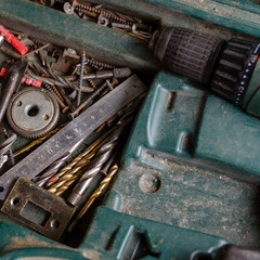 Old toolbox with a drill and drills.