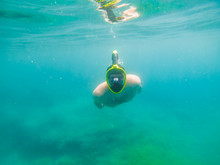Man Swimming Underwater With Snorkeling Musk