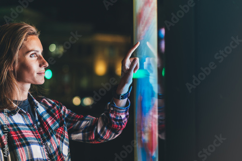 Fotomural girl pointing finger to blank monitor display, hipster touch screen technology o