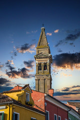 Canvas Print - n old church bell tower over brightly colored homes in Burano