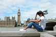 guy on city trip in London, youn men at waterfront by the river Thames at the famous places in London,Big Ben and westminster bridge in London 
