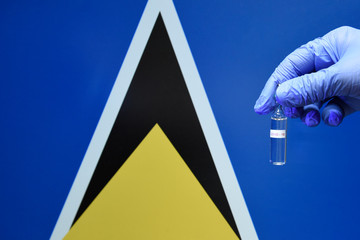 Corona virus or Covid-19 in saint Lucia , sample blood tube in hand with saint Lucia flag on background