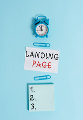 Fototapete - Text sign showing Landing Page. Business photo text Web page that a user arrives at after clicking a hyperlink Alarm clock squared blank paper sheet notepad clips colored background
