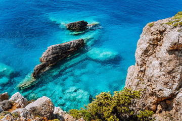 Wall Mural - Rock cliffs and clear water at mediterranean sea coast. Greece