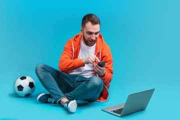 Poster - Young bearded man betting online at bookmaker's website