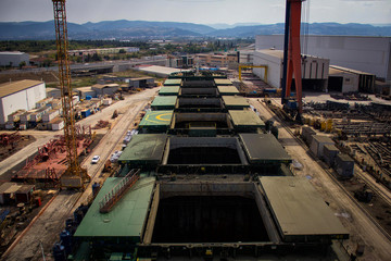 Poster - A large tanker cargo ship is being renovated and painted in shipyard dry dock.