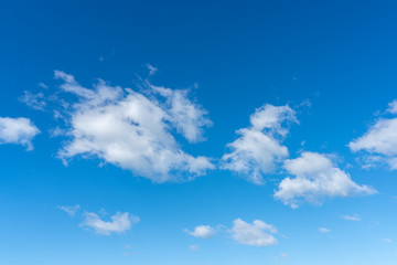 little white clouds on a blue sky.
