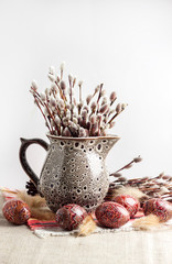 Wall Mural - Easter still life with Pysanka and willow branches in ceramic jug on traditional Ukrainian cloth. Decorated Easter eggs, traditional for Eastern Europe culture