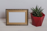 Fototapeta Sypialnia - Mock up frame on a white wooden table with cactus in the room.