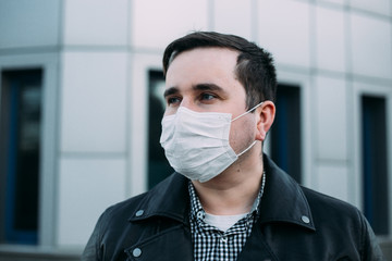 Sick man with flu wearing mask, epidemic flu concept on the street.