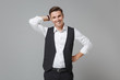 Funny young business man in classic black waistcoat shirt posing isolated on grey wall background studio portrait. Achievement career wealth business concept. Mock up copy space. Put hand on head.