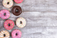 Traditional Doughnuts With Multicolored Glaze Laid Out On White Painted Wooden Table. Top View, Copy Space.