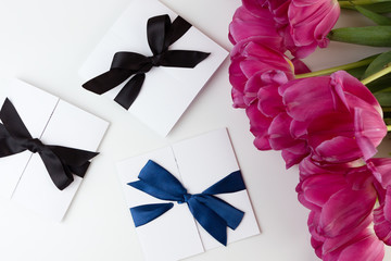 Wall Mural - Gift card and Lovely tulip bouquet isolated on white backdrop, holiday postcard with copy space. Gift mockup.