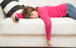 © Lsantilli - bored little girl lying on the sofa watches TV during the Coronavirus quarantine