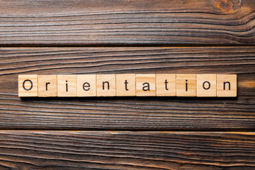 Orientation word written on wood block. Orientation text on wooden table for your desing, concept