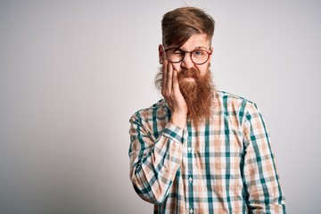 Sticker - Handsome Irish redhead man with beard wearing glasses and hipster shirt thinking looking tired and bored with depression problems with crossed arms.