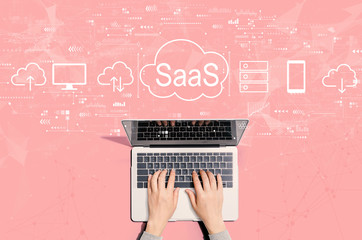 saas - software as a service concept with person using a laptop computer