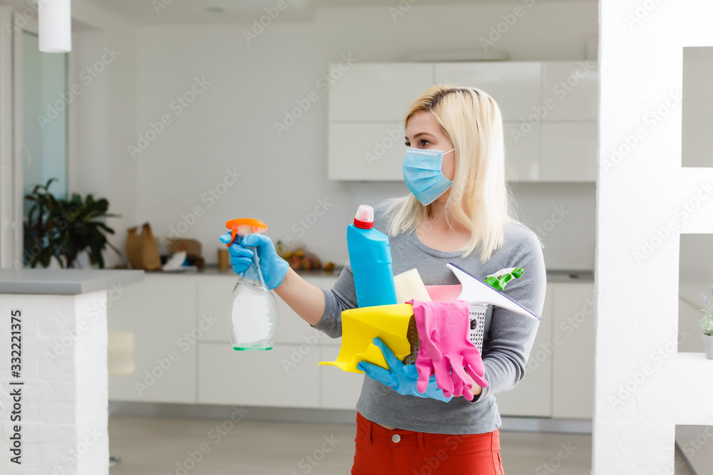Coronavirus Pandemic. A disinfector in a protective mask sprays disinfectants in the room. Prevention of Coronavirus Disease. Environmental Cleaning and Disinfection with Coronavirus Epidemic - obrazy, fototapety, plakaty 