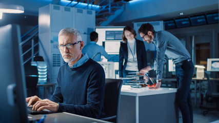 Fototapete - Diverse International Team of Industrial Engineers and Scientists Working in Research Laboratory / Development Center. People Working on Efficient Engine Design, Using Computers, Advanced Technology