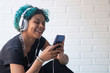 © carballo - portrait of young woman with mobile phone and headphones listening to music