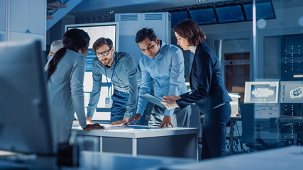 Poster - Engineers Meeting in Technology Research Laboratory: Engineers, Scientists and Developers Gathered Around Illuminated Conference Table, Talking and Finding Solution. Industrial Design Facility