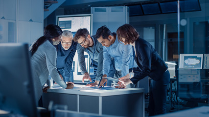 Poster - Engineers Meeting in Technology Research Laboratory: Engineers, Scientists and Developers Gathered Around Illuminated Conference Table, Talking and Finding Solution. Industrial Design Facility