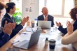 © Krakenimages.com - Group of business workers smiling happy and confident in a meeting. Working together looking at presentation using board and laptop applauding at the office.