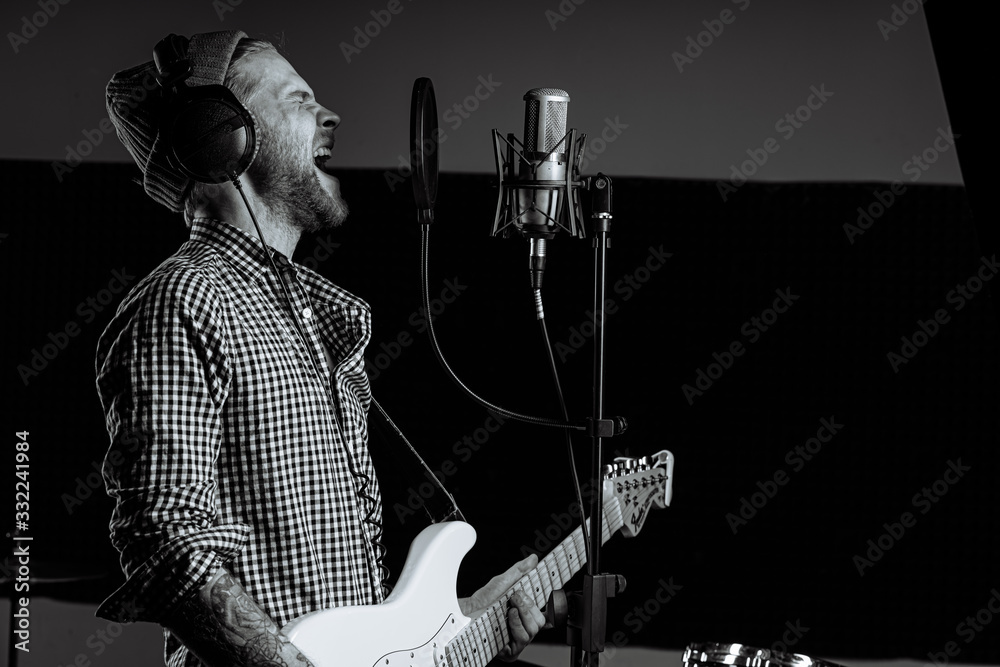 black and white photo of singing caucasian guitarist in recording ...