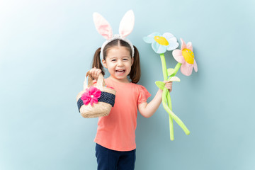 Wall Mural - Beautiful little girl laughing and getting excited about celebrating Easter