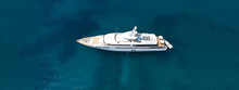 Aerial Drone Top Down Photo Of Luxury Yacht With Wooden Deck Anchored In Open Ocean Sea