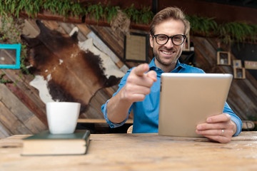 Wall Mural - businessman holding tablet while pointing forward happy