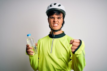 Poster - Young handsome cyclist man wearing security bike helmet drinking bottle of water annoyed and frustrated shouting with anger, crazy and yelling with raised hand, anger concept