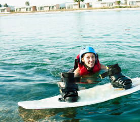 young smiling girl on wake board in water, happy lifestyle people on vacations