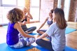© Krakenimages.com - Young beautiful group of sportswomen smiling happy practicing yoga. Sitting on the mat speaking after class at gym