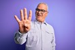 © Krakenimages.com - Middle age handsome hoary man wearing striped shirt and glasses over purple background showing and pointing up with fingers number four while smiling confident and happy.