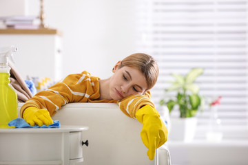 Wall Mural - Lazy young woman wiping table at home. Cleaning and housework