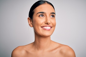 Close up of young beautiful woman with clear and pure skin. Perfect and clean skincare wearing natural makeup. Smiling happy looking fresh and healthy.