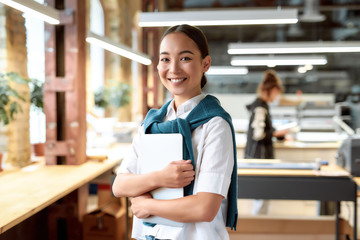 Think success. Confident asian female office worker posing indoors