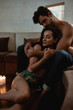 © Svitlana - You give me that feeling. Couple relaxing half dressed in living room. Boyfriend and girlfriend cuddling while having romantic evening together