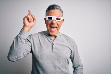 Sticker - middle age handsome grey-haired man using 3d glasses over isolated white background pointing finger 