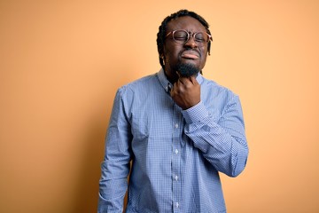 Sticker - Young handsome african american man wearing shirt and glasses over yellow background Touching painful neck, sore throat for flu, clod and infection