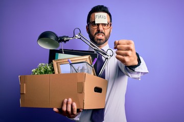 Poster - Young handsome businessman with beard holding cardboard box with fired reminder on head annoyed and frustrated shouting with anger, crazy and yelling with raised hand, anger concept