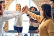 © Krakenimages.com - Group of business workers standing with hands together highing five at the office