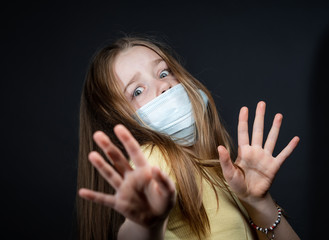 Girl in a medical protective mask. Coronavirus epidemic. Conceptual image. Stop the virus. Protective equipment.