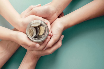 child and parent hands holding money jar, donation, saving, charity, family finance plan concept, Coronavirus economic stimulus rescue package, superannuation concept