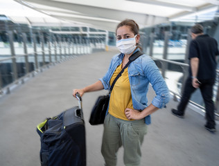 Wall Mural - Traveler with face mask affected by coronavirus travel ban and COVID-19 pandemic flight restrictions