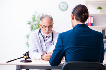 Wall Mural - Male doctor in courthouse meeting with lawyer