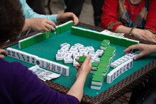 People Playing Mahjong In A Tea Garden In China